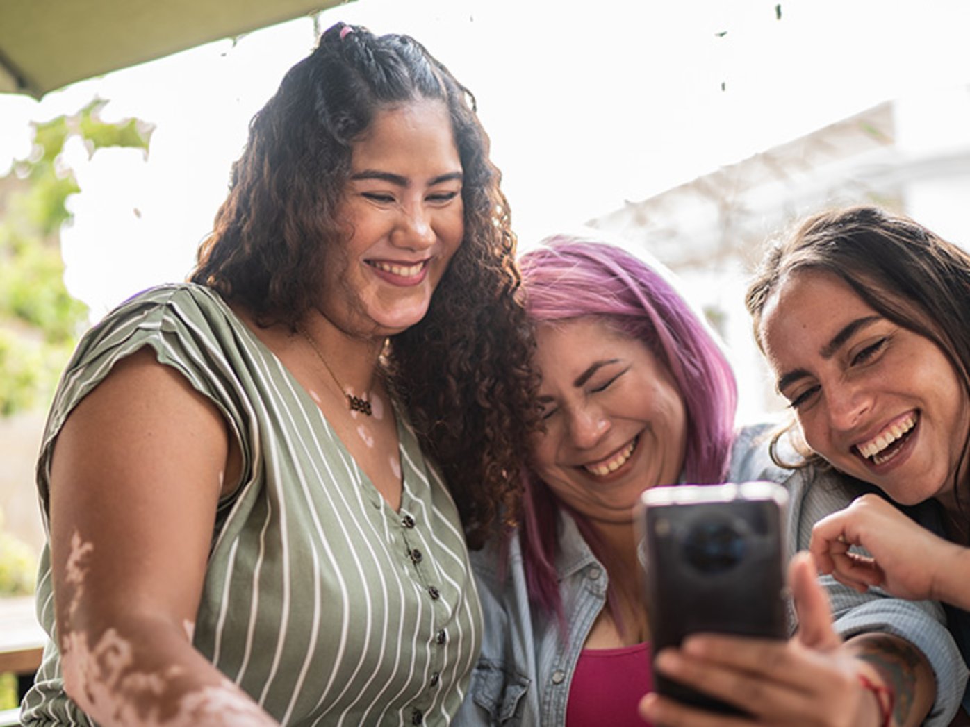 Friends laughing and taking selfies