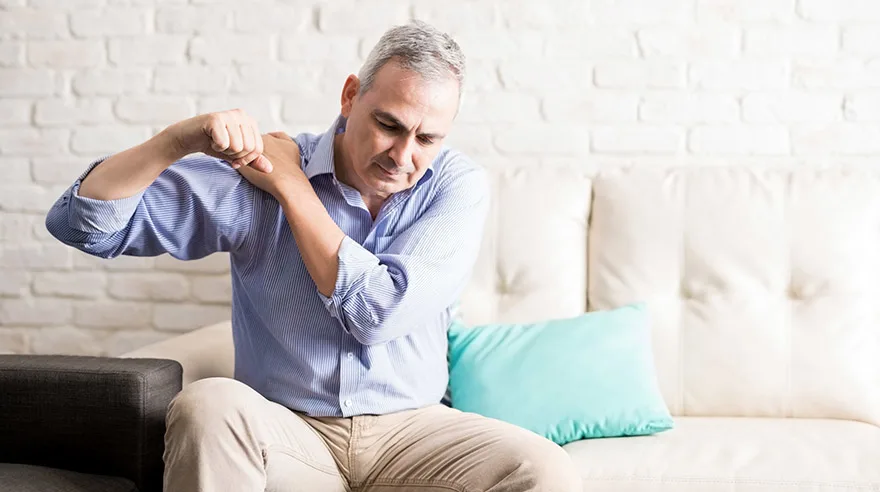 Man holding his shoulder in pain