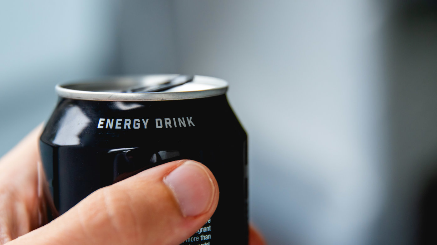 Person holding an energy drink