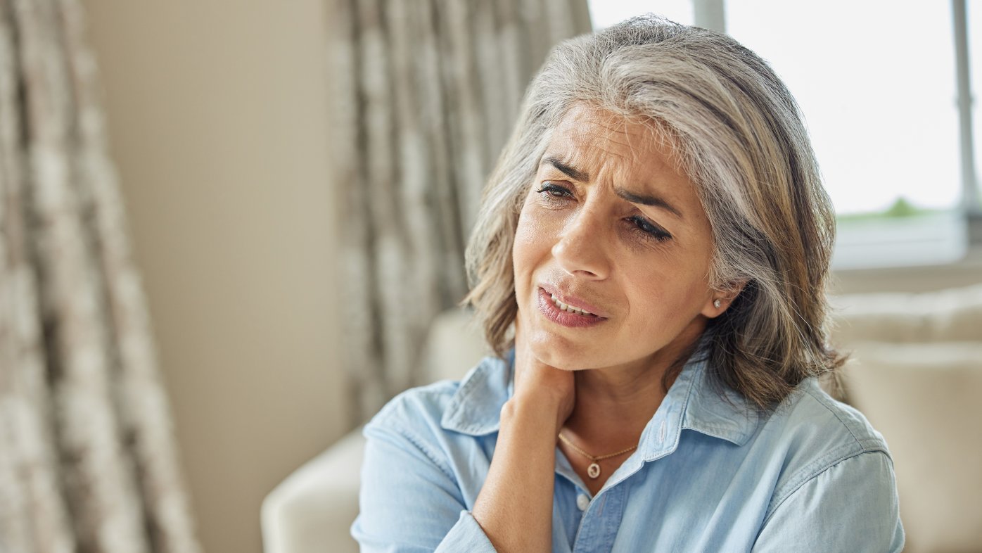 Woman experiencing neck pain