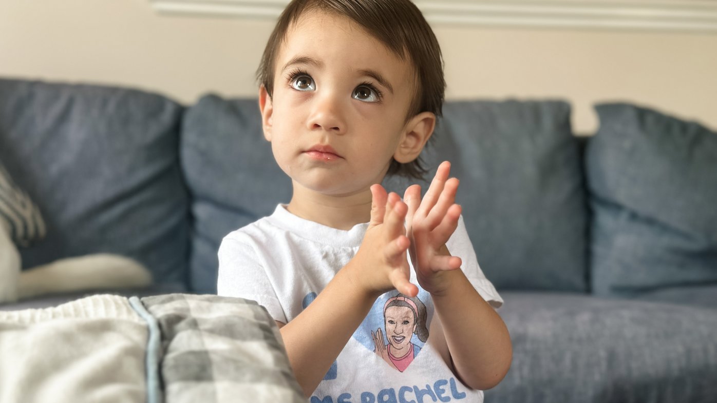 Toddler clapping to the TV