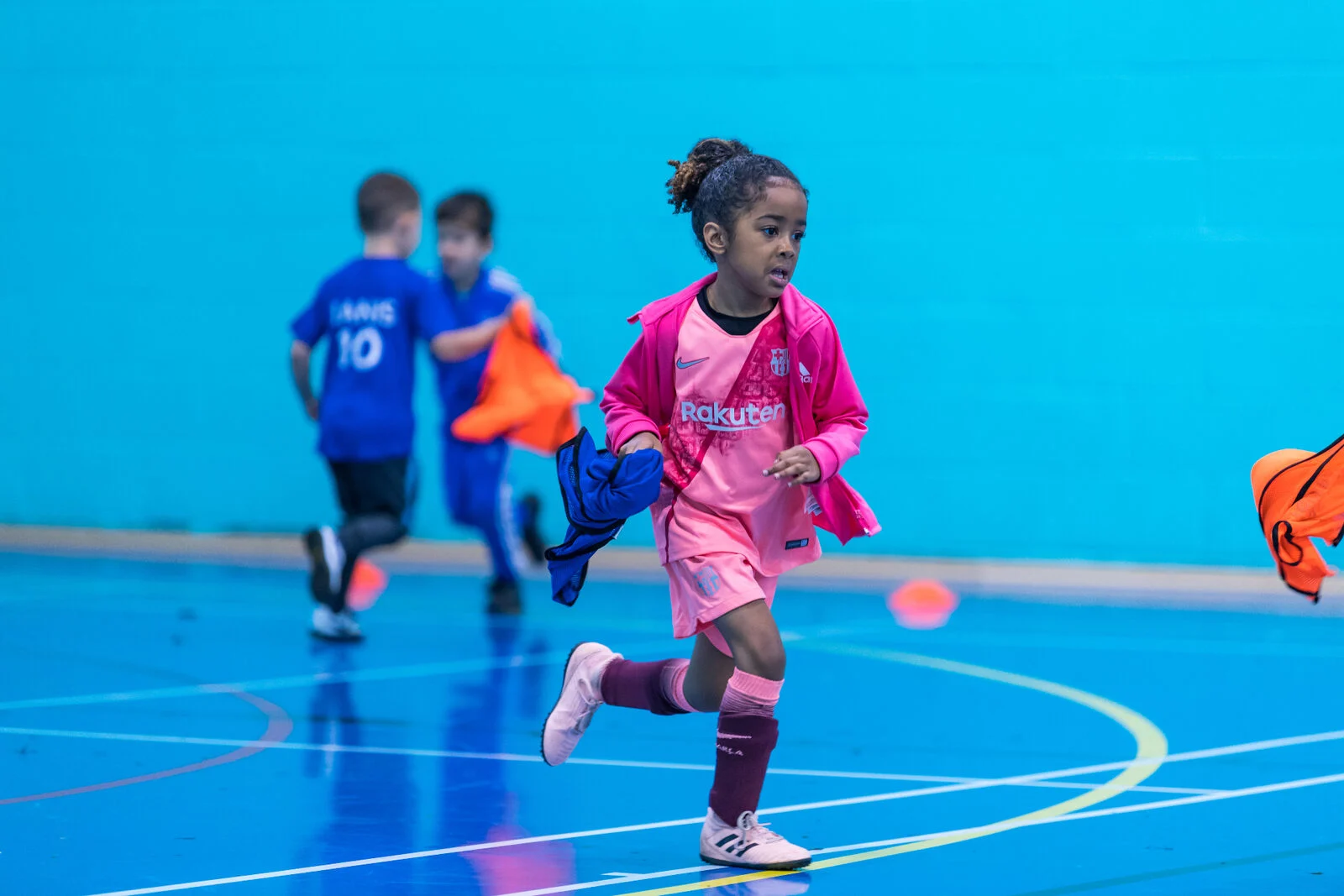 Girl running during football training