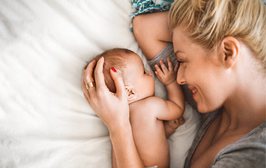 Frau hält Baby hoch