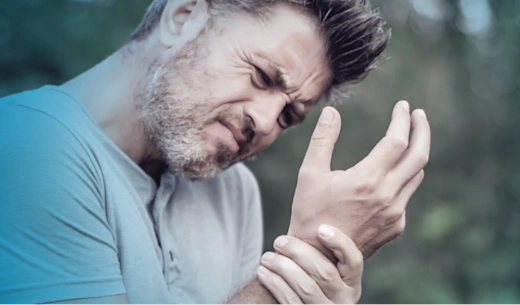 A man holding his wrist in pain.