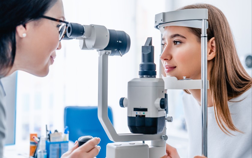 Patient receiving retinal scan during comprehensive eye exam
