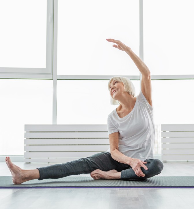 Joyful cataract patient performing yoga