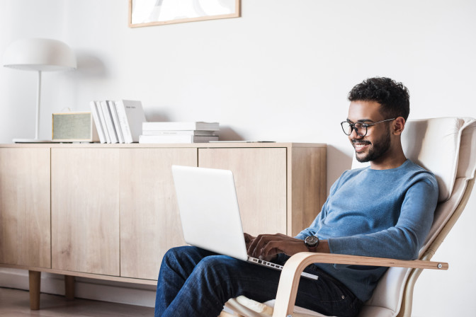 Young man looking for local careers in eye care on laptop