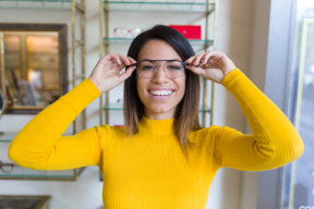 Woman with yellow sweater and glasses