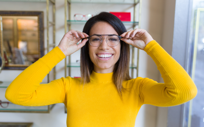 Woman with yellow sweater and glasses