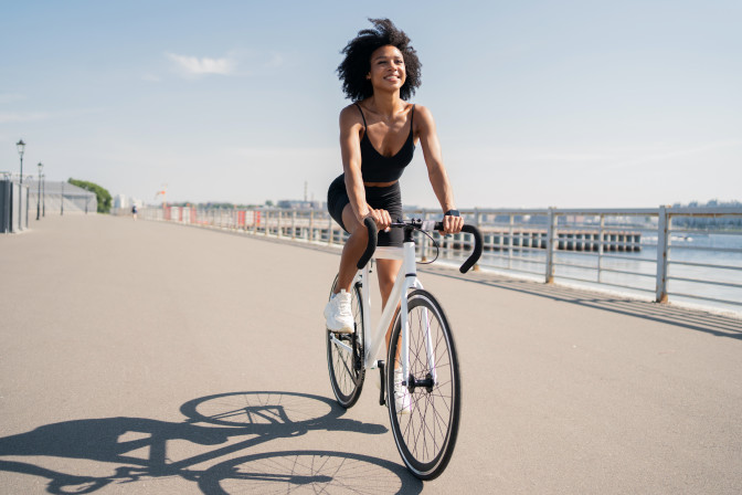 Girl biking along pier wearing Contact Lenses