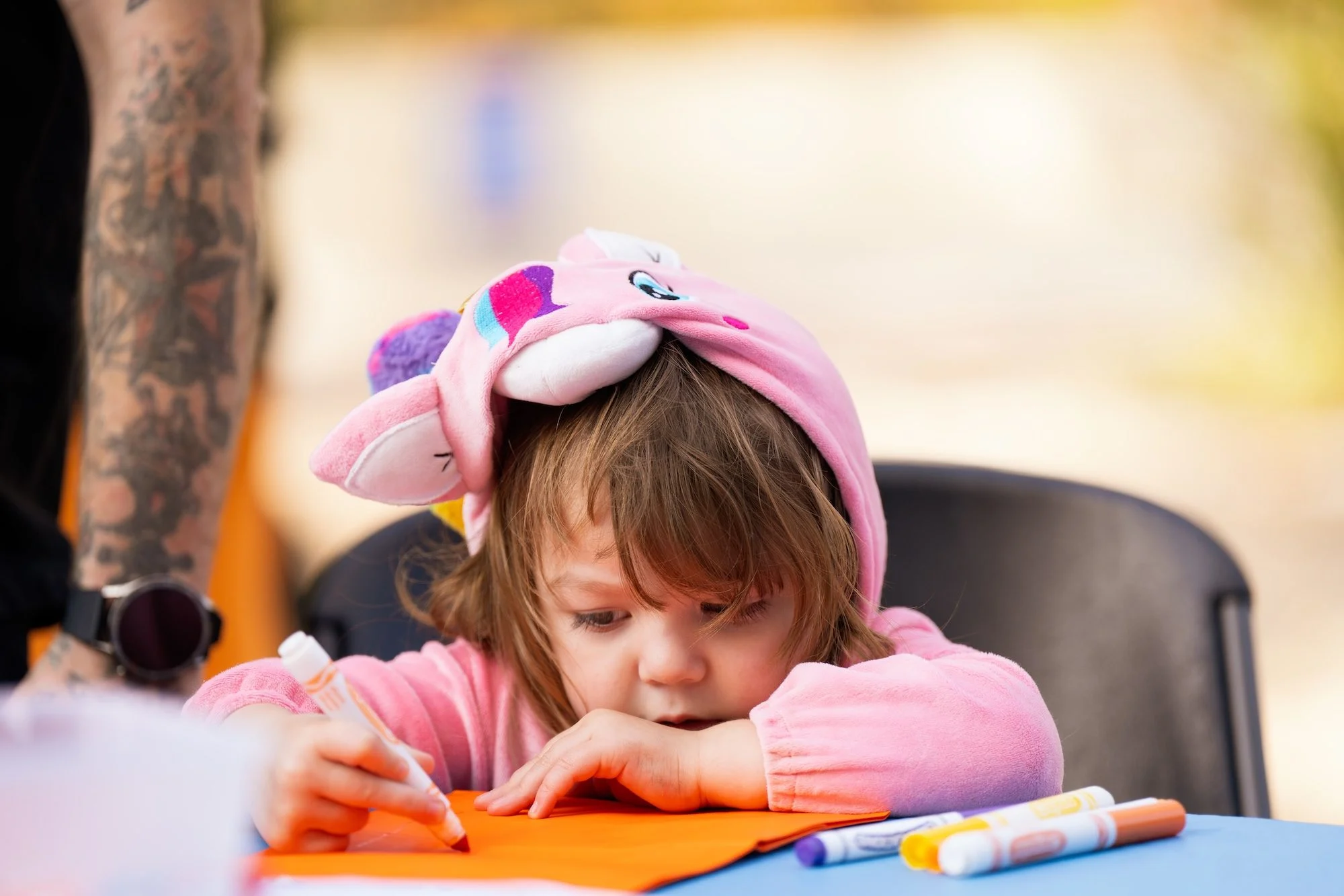 Child Coloring in Animal-Themed Hoodie
