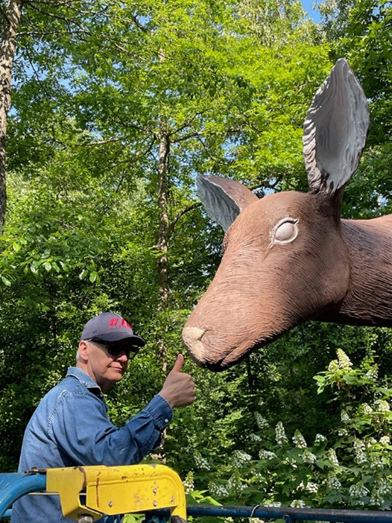 Tony Tasset giving a “thumbs up” with Deer during the painting process.