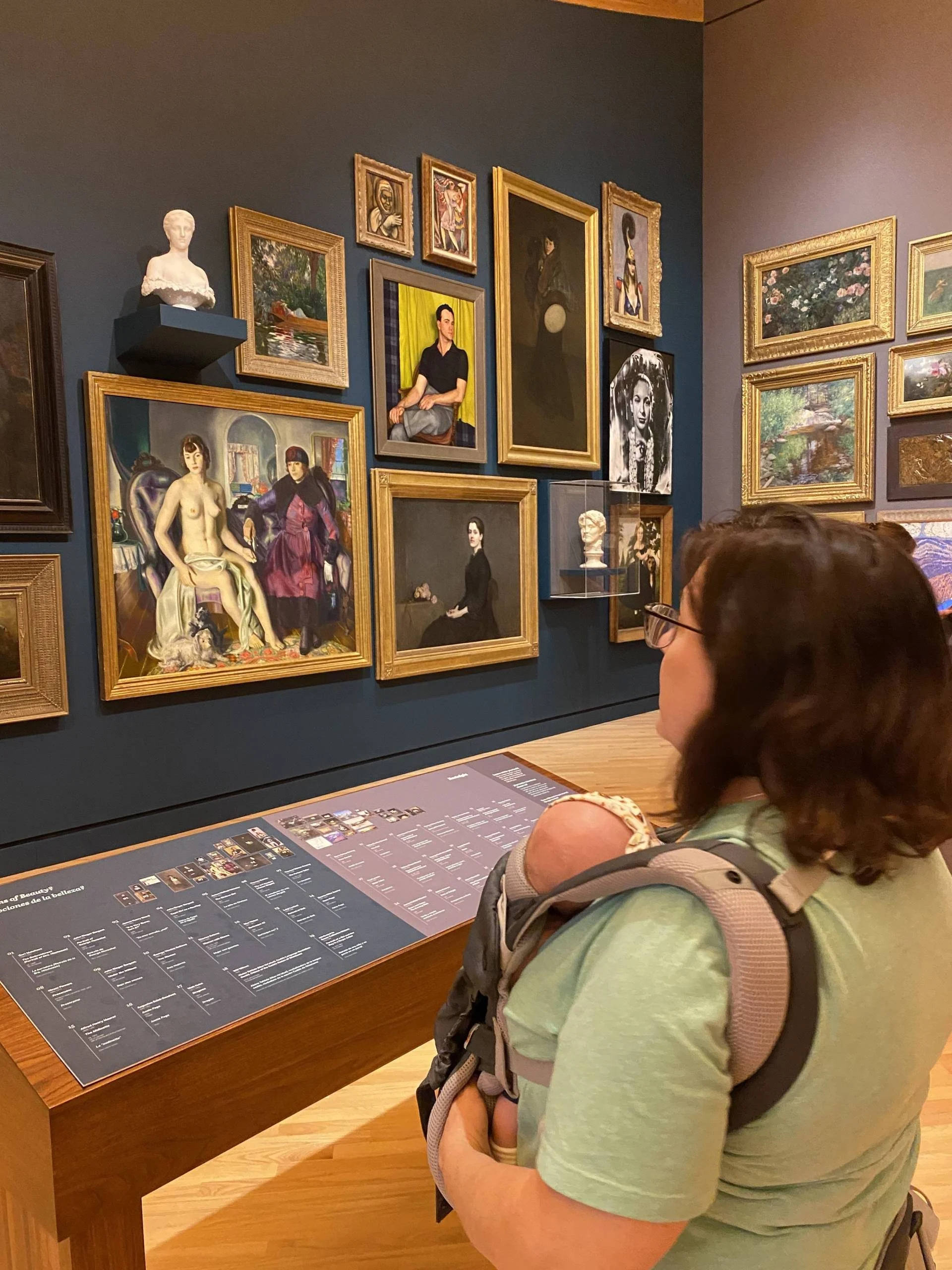 woman looking at art with baby