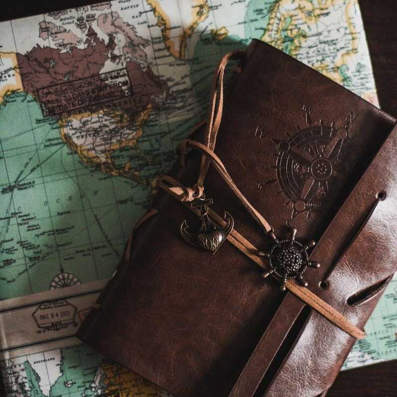 A map and travel journal on a black background
