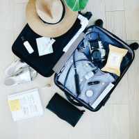 Flat lay of a packed vacation suitcase