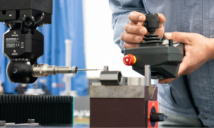 A photograph of a CMM machine inspecting a part