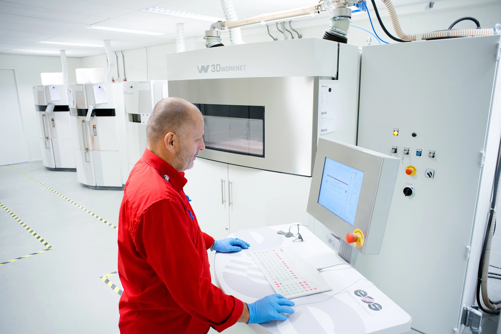 Man operating a 3D printing machine