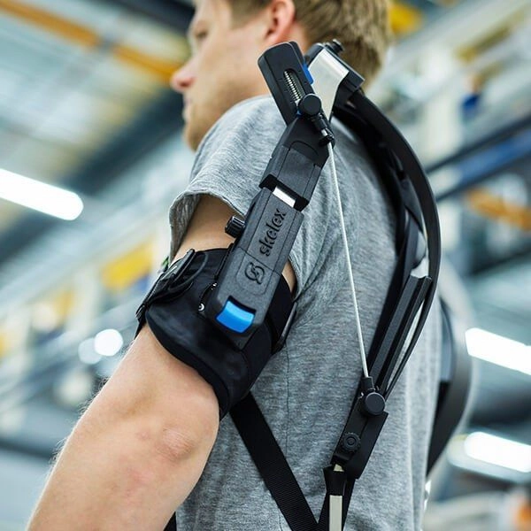Man at work wearing Skelex exoskeleton