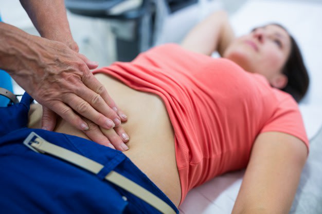 woman-getting-ultrasound-of-a-abdomen-from-doctor 1170-2191