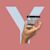 Hand holding an N26 card with the letter Y in the background.