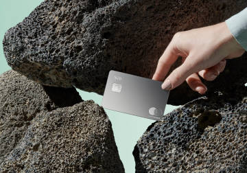 Metal card on rocks.