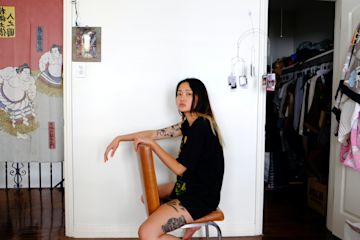 Woman sitting backwards on a chair facing the camera.