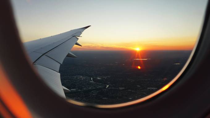 View of a city and the sunset from the window of a plane.