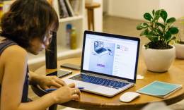 Woman working on a lap top.