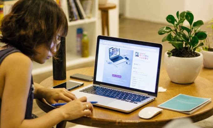 Woman working on a lap top.