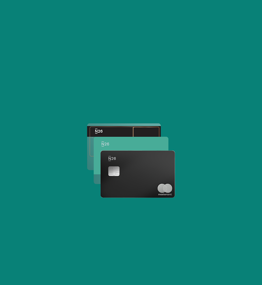 The image shows two N26 bank cards on a teal background. One is a transparent card with a visible chip and black header, placed behind a solid green N26 Mastercard with the Mastercard logo in the bottom right corner.