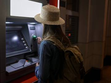 woman withdrawing money from an atm.