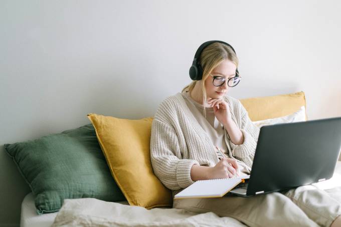 Una freelance che lavora al computer con le cuffie.