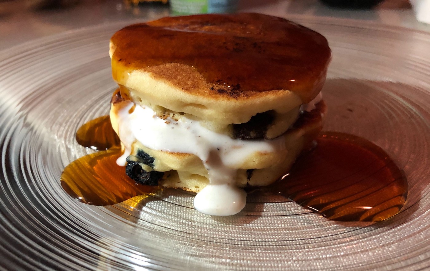 Pancakes with maple syrup on a plate.