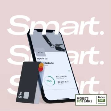 Image of a mobile phone showing a subaccount on the screen and a black debit card in the side with Forbes best bank logo.