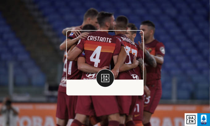 Roma players celebrate on the pitch after a goal.