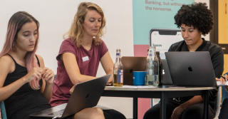 Three women sitting at the table during a N26 tech event.