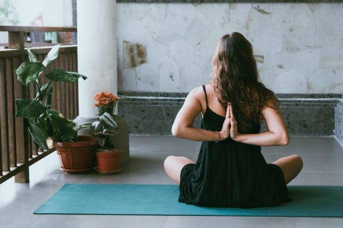 A person doing yoga indoors in a sitting position.