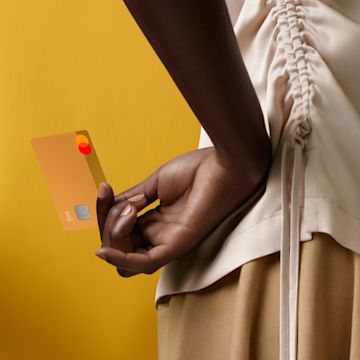 A person holding a Sand colored N26 You card behind their back.