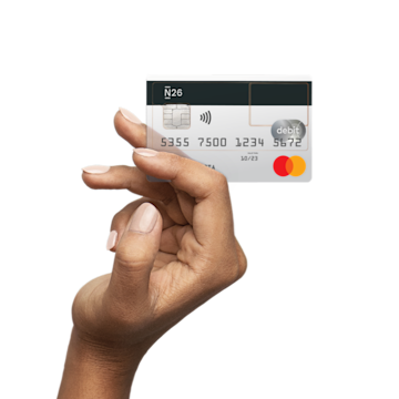 An elevated hand holding a transparent N26 credit card in their hand.