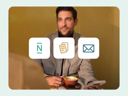 A man enjoying a cappuccino with three N26 icons in the foreground.