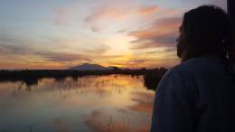 Traveler looking at a lake.