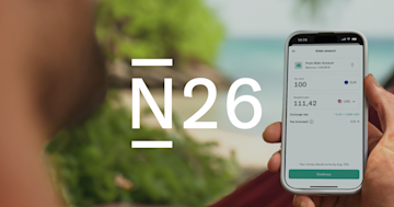 Hand holding a mobile showing an international bank transfer in the N26 app. 