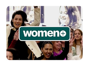 A group of women are smiling and raising their hands in a celebratory manner, with the word "women+" in a green box overlaid on the image.