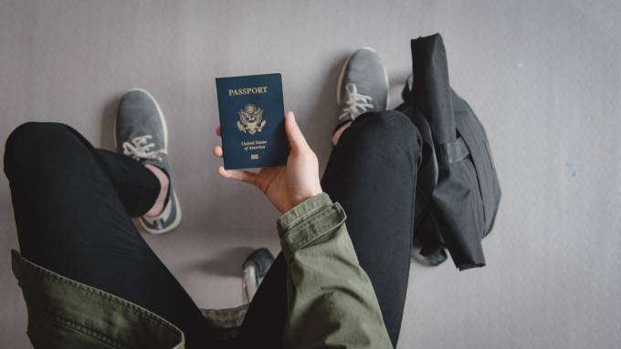 Man holding a passport in his hand.