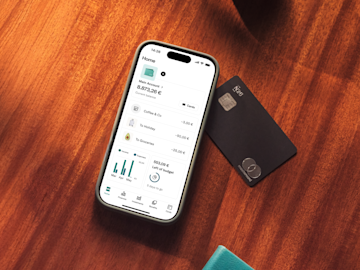 A smartphone displays the N26 banking app home screen next to a black N26 Mastercard.