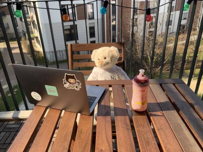 A stuffed animal in front of an N26 computer.