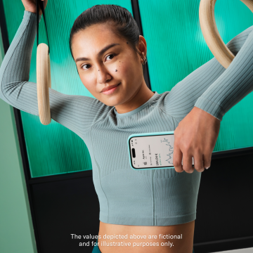 Gymnast wearing teal color clothes and holding a mobile with the N26 app open. In the foreground there is pop up displaying the balance and profitability in the Stocks and ETFs account and Crypto account. 