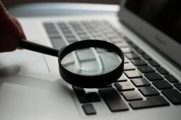 Magnifying glass over keyboard.