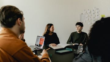 People working around a table.