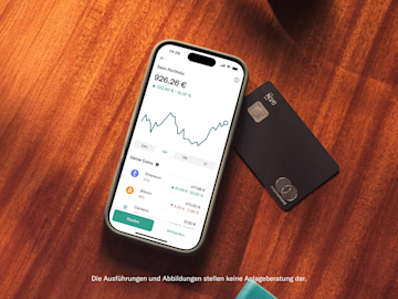 Ein Smartphone zeigt ein Kryptowährungs-Portfolio mit Guthaben und einem Liniendiagramm neben einer schwarzen N26 Mastercard.